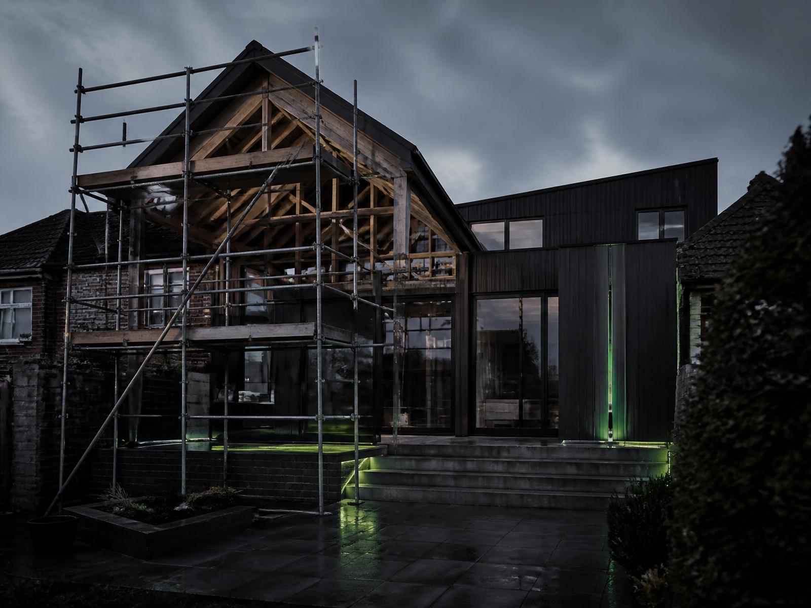 Modern UK house extension under construction at dusk